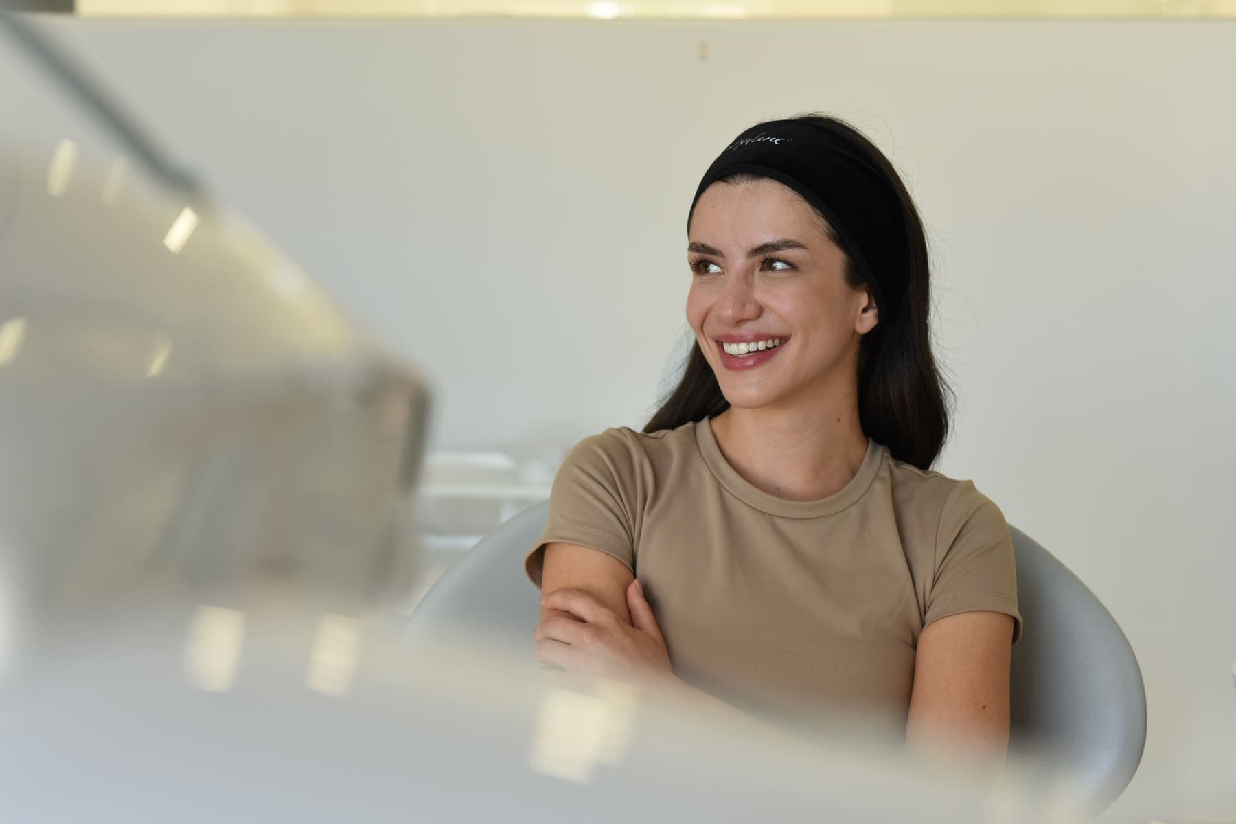 Pacientă zâmbind în cabinetul clinicii, înainte de o ședință de rejuvenare facială
